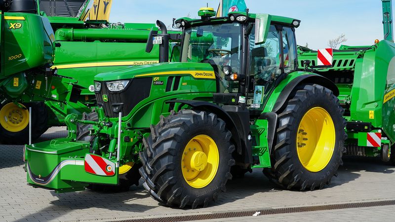 Green John Deere 6R 185 tractor at a farm show