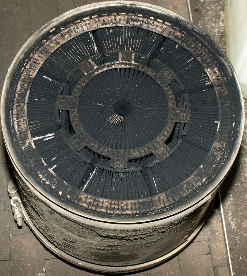 Soot-loaded diesel particulate filter element removed for cleaning
