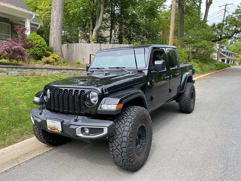 Black Jeep Gladiator EcoDiesel pickup on a driveway