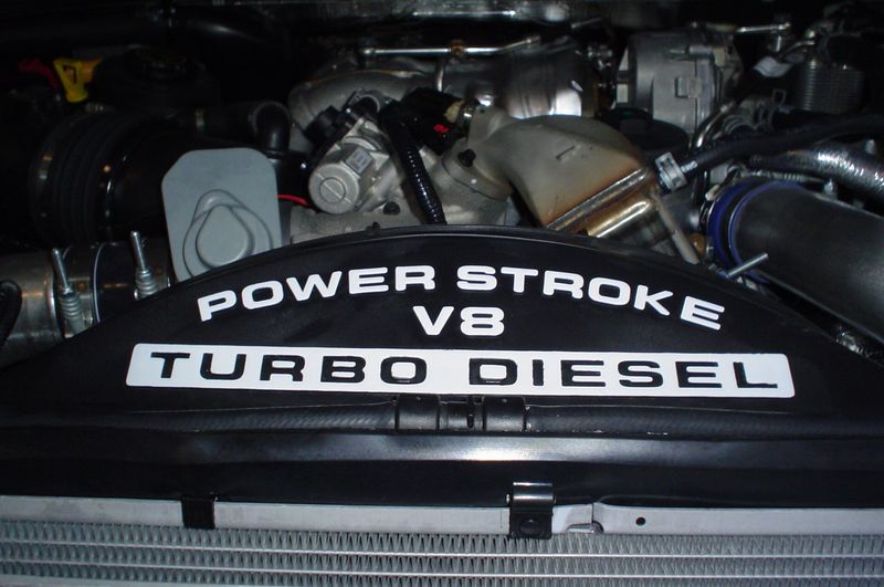 Engine bay of a Ford Super Duty with the 6.4L Power Stroke V8 Turbo Diesel cover
